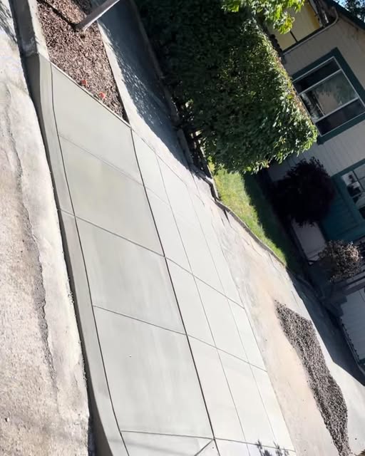 Freshly finished concrete driveway with precise control joints