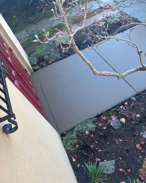 Smooth finished concrete garden walkway beside a residence
