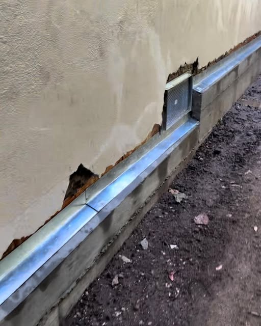 Exterior foundation waterproofing and metal flashing detail